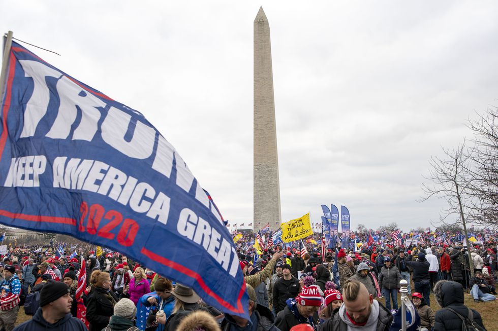 With the Washington Monument in the background, people attend a rally in support of President...