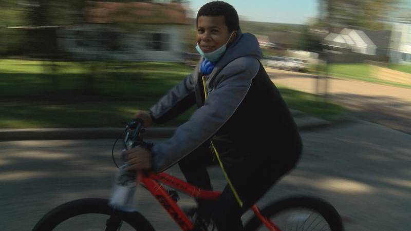 Kofi Louis rides his new bike thanks to the community's help