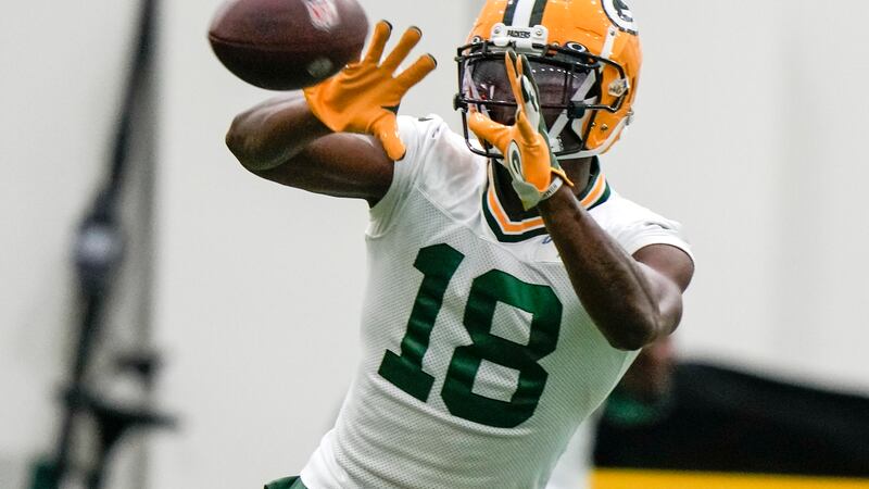 Green Bay Packers' Malik Heath catches a pass during an NFL football rookie mini camp practice...