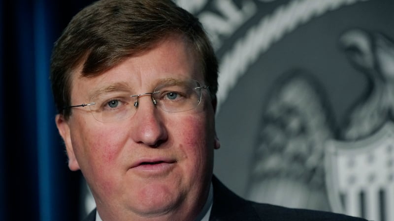 FILE - In this Aug. 19, 2021 file photo, Gov. Tate Reeves responds to a reporter's question...