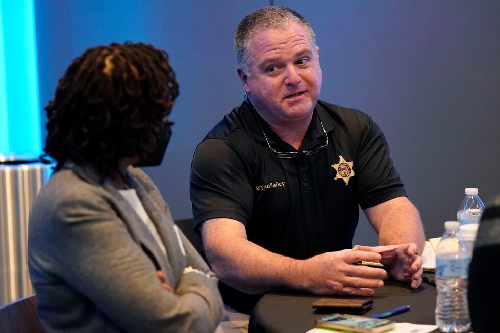 Rankin County Sheriff Bryan Bailey, right, speaks to an attendee at an employer engagement...