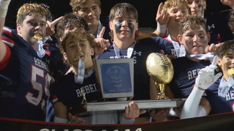 Tri-County Academy players pose with the championship trophy, after defeating Bowling Green in...