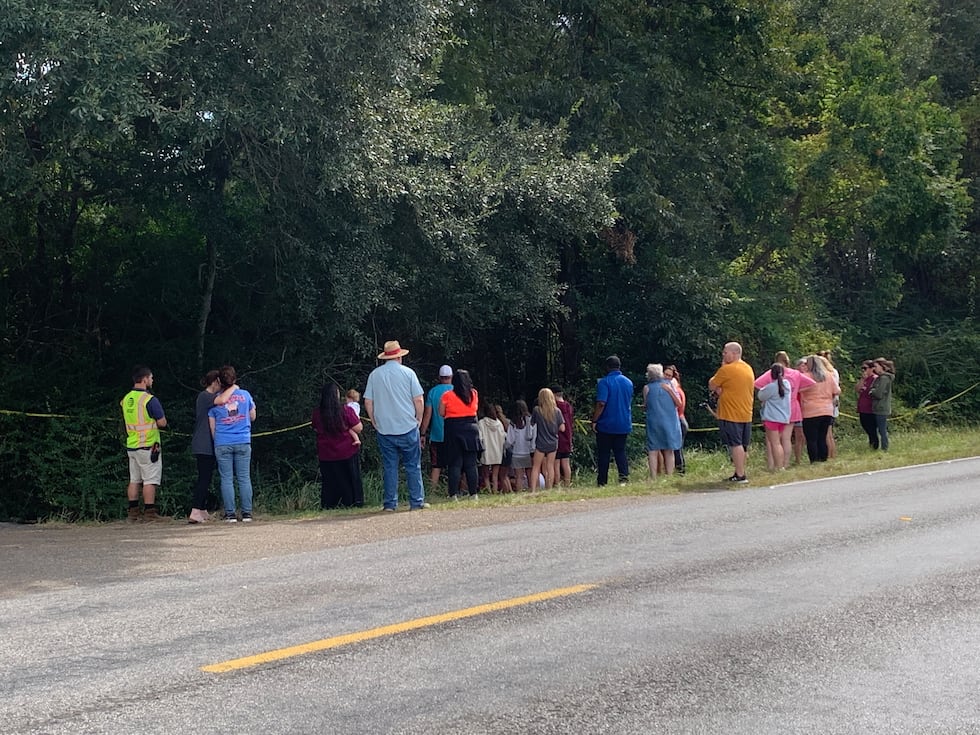 Family and friends memorialize the two girls at the site of the crash.