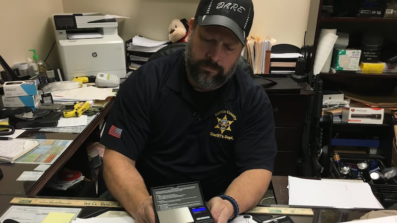 Narcotics Investigator Brett McAlpin reviews evidence of ecstasy, cocaine, marijuana,...