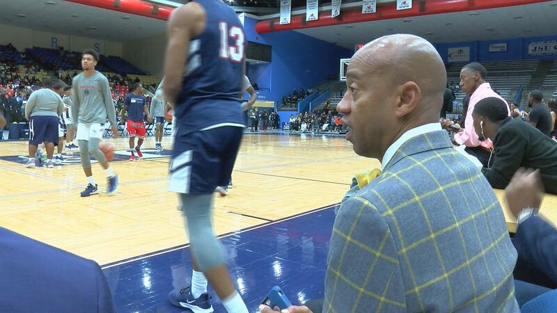Coach looking on the floor at his starting five at JSU.