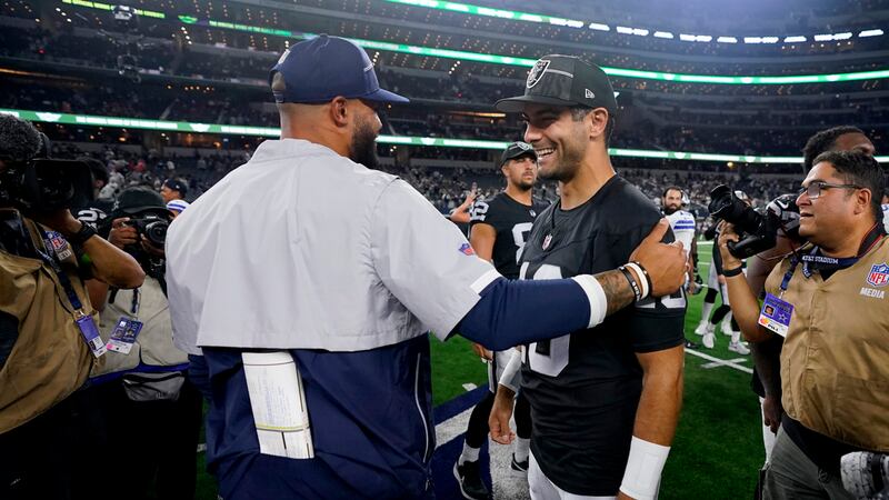 Dallas Cowboys quarterback Dak Prescott, center left, and Las Vegas Raiders quarterback Jimmy...