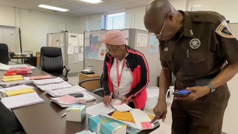 District 5 Election Commissioner Shirley Varnado works with Hinds Co. Sheriff's Deputy Lee Van...